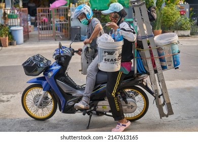 Editorial use only; an air conditioner cleaner team with their equipment on a motorcycle, taken at Pathumthani, Thailand, in April 2022.         
