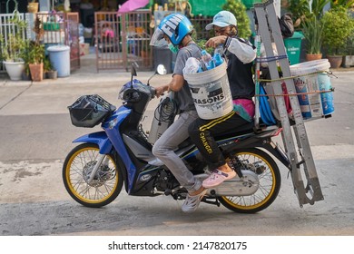 Editorial use only; an air conditioner cleaner team with their equipment on a motorcycle, taken at Pathumthani, Thailand, in April 2022.         