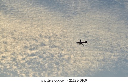 Editorial Use Only; An Airplane Flies Across An Evening Sky Just After Sunset, Taken At Pathumthani, Thailand, In May 2022.     