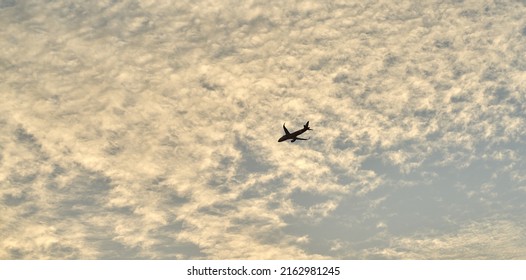 Editorial Use Only; An Airplane Flies Across An Evening Sky Just After Sunset, Taken At Pathumthani, Thailand, In May 2022.     