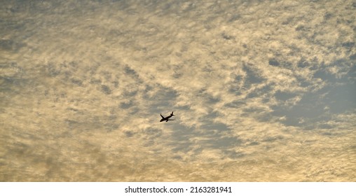 Editorial Use Only; An Airplane Flies Across An Evening Sky Just After Sunset, Taken At Pathumthani, Thailand, In May 2022.     