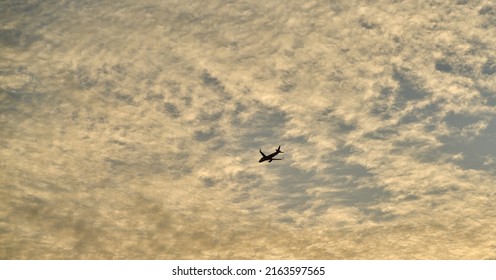 Editorial Use Only; An Airplane Flies Across An Evening Sky Just After Sunset, Taken At Pathumthani, Thailand, In May 2022.     