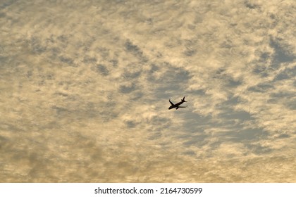 Editorial Use Only; An Airplane Flies Across An Evening Sky Just After Sunset, Taken At Pathumthani, Thailand, In May 2022.     