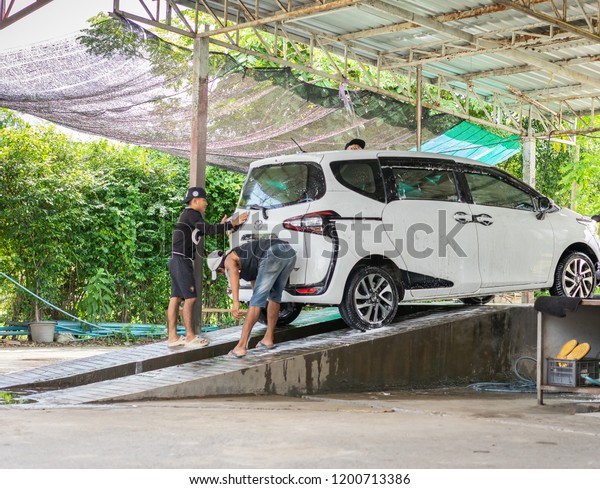 Editorial use only; car being\
washed in a car wash, taken at Pathumthani, Thailand, in October,\
2018.