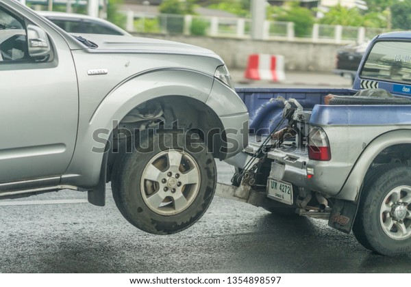 Editorial use only; a car  being\
towed on road, taken at Pathumthani, Thailand, in March\
2019.