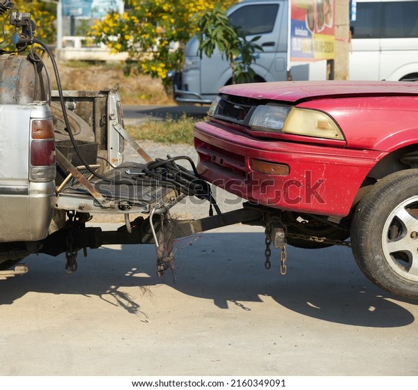 Editorial use\
only; a car being towed by a pickup truck, taken at Pathumthani,\
Thailand in January\
2019.