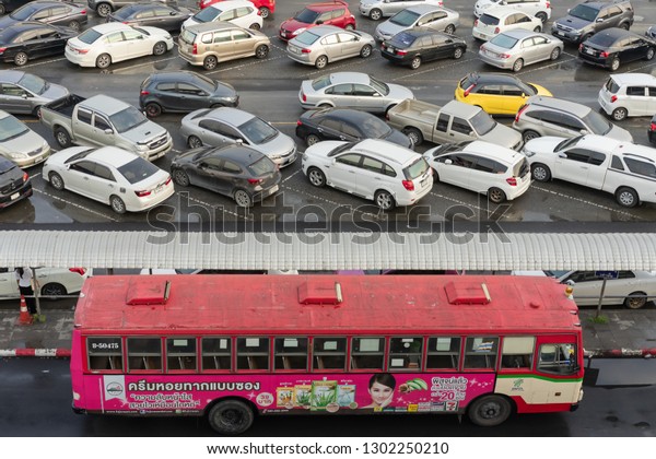 Editorial use only; cars parked at at an outdoors\
car park, next to a train station, taken at Bangkok, Thailand, in\
January 2019.