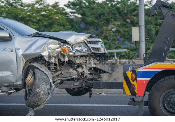 Editorial use\
only; a crashed car being towed by a tow truck, taken outside\
Bangkok, Thailand on December 1st,\
2018.