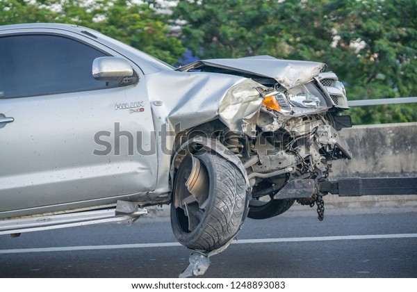 Editorial use only; a\
crashed car being towed, taken outside Bangkok, Thailand, in\
November, 2018.