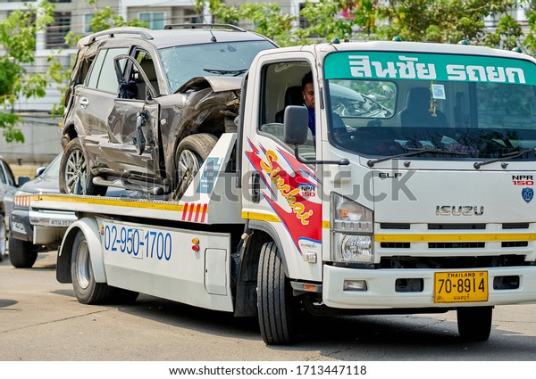  Editorial use only; a crashed car being towed by a tow\
truck, taken outside Bangkok, Thailand in April 2020.              \
              