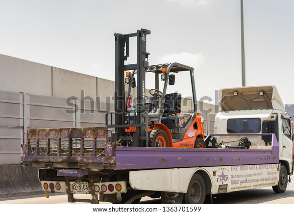 Editorial use only; a forklift\
truck on a tow truck, taken at Bangkok, Thailand, in April\
2019.