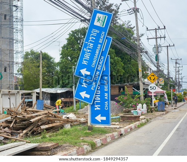 Editorial use only; funny road signs mounted vertically\
instead of horizontally, taken at Phetchaburi, Thailand, in October\
2020.       
