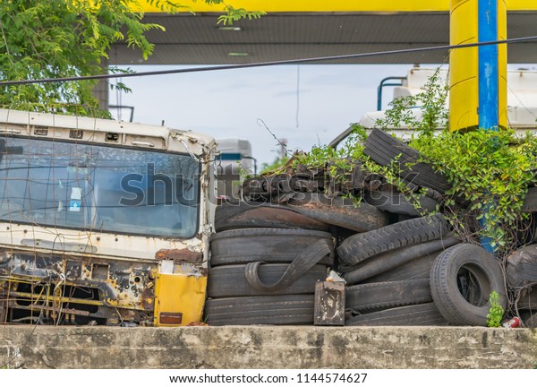 Editorial use only; junk yard,\
with old worn car tires, note the KFC cup in right side corner,\
junk food concept, taken at Samut Sakhon, Thailand, in July\
2018.