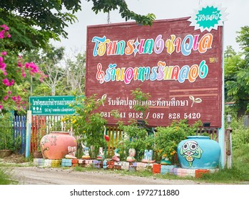 Editorial use only; a large billboard advertising a homestay accommodation, written in Thai script, taken at Phetchaburi, Thailand, in October 2020.             