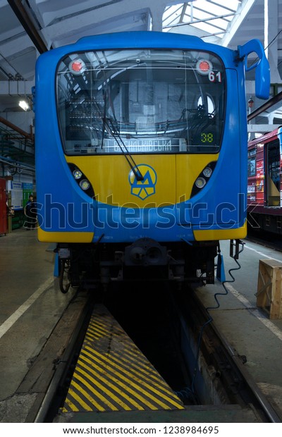 Editorial use only. At the maintenance\
hall: subway train standing on pit for technical inspection. Subway\
car shed “Obolon”, Kiev, Ukraine. November 22,\
2018