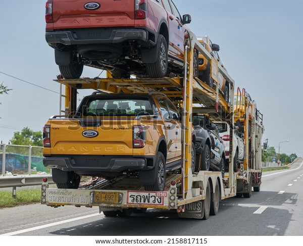 Editorial use only;\
new cars being transported on a tow truck, taken at Pathumthani,\
Thailand, in May 2022.\
