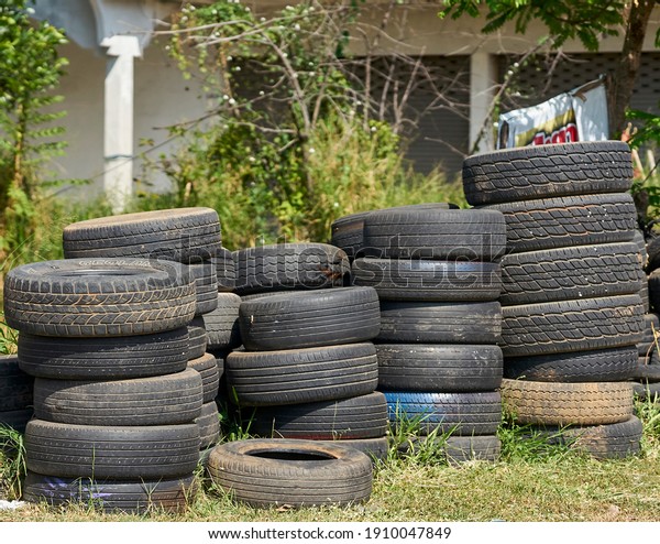 Editorial use only; old used car\
tires being transported on an overloaded truck, taken at\
Pathumthani, Thailand, in December 2020.                           \
   