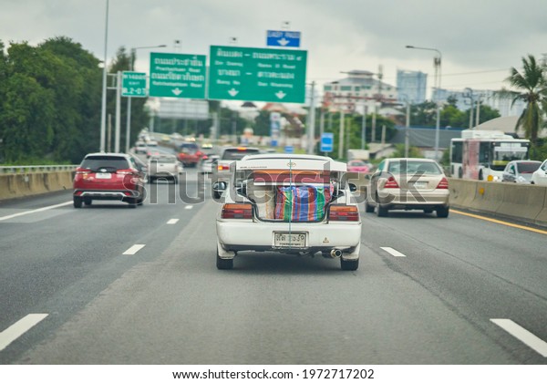 Editorial use only;\
an overloaded car trunk, driving into Bangkok, Thailand, taken in\
October, 2020.           \
