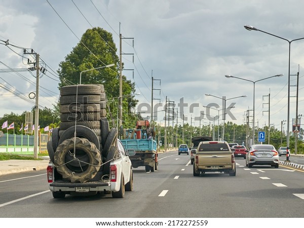 Editorial use\
only; an overloaded pickup truck carrying used rubber tires, taken\
at Sisaket, Thailand, in June 2022.\
