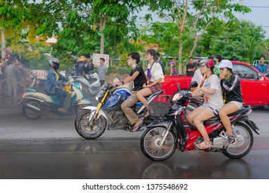 Editorial use only; people riding motorcycles, during Songkran festival, taken at Pathumthani, Thailand, in April 2019.