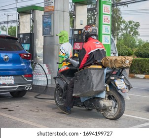  Editorial use only; a postman on a motorcycle at a gas station, taken at Pathumthani, Thailand, in March 2020.                                  