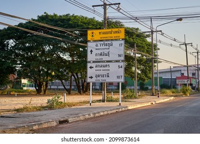 Editorial use only; a road information sign, with directional arrows, and text in Thai and English language, taken at Sakon Nakhon, Thailand, in December 2021.            