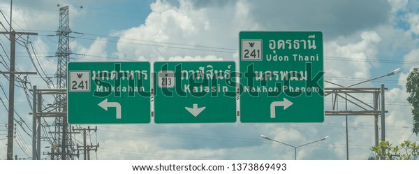 Editorial use only;\
road signs and directions, over a highway, taken at Sakon Nakhon,\
Thailand, in October\
2018.