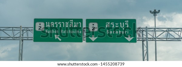 Editorial use\
only; road signs over a highway giving traffic directions, taken at\
Saraburi, Thailand, in July\
2019.