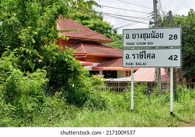 Editorial use only; a sign post in English and Thai script, listing the number of kilometers to two towns, taken at Sisaket, Thailand, in June 2022.