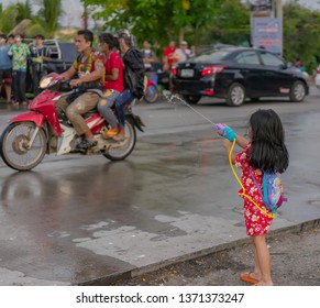 Editorial use only; a small girl plays with a water gun, during the Thai New Year festival, taken at Pathumthani, Thailand, in April, 2019.