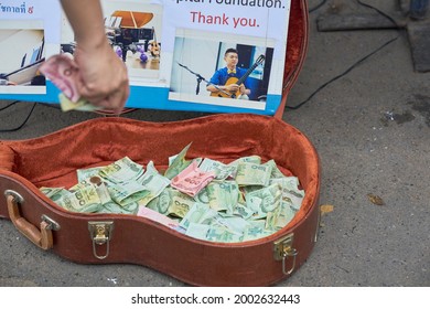 Editorial Use Only; A Street Busker Uses A Guitar Case To Collect Tips For Playing Music, Taken At An Outdoor Market, Taken At Bangkok, Thailand, In August 2018.