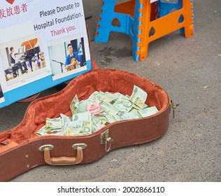 Editorial Use Only; A Street Busker Uses A Guitar Case To Collect Tips For Playing Music, Taken At An Outdoor Market, Taken At Bangkok, Thailand, In August 2018.