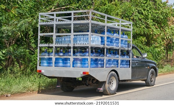 Editorial use only; a truck delivering drinking\
water in large plastic bottles, taken at Buriram, Thailand, in July\
2022.