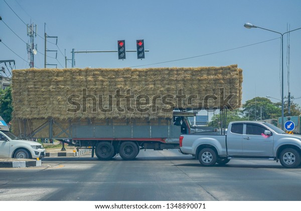 Editorial use only;\
a truck full of hay, at a traffic lights, taken at Phetchabun,\
Thailand, in March\
2019.