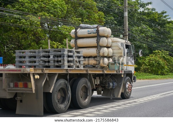 Editorial use only; a truck powered by LPG gas,\
with green tree background, clean energy concept, taken at\
Saraburi, Thailand, on July 4, 2022.     \
