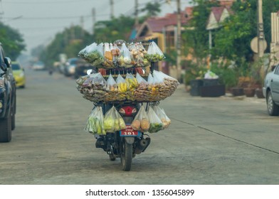 Editorial use only; a variety of fresh fruit and vegetables and other food for sale, on a motorcycle, taken at Pathumthani, Thailand, in January 2019.