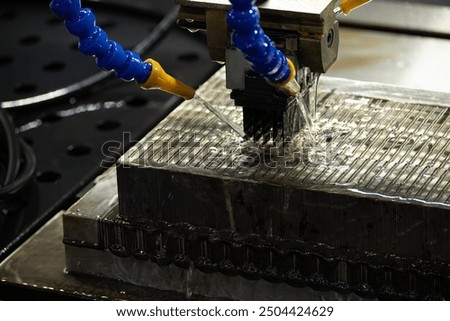 The EDM machine working with graphite electrode by liquid coolant method. The mold and die manufacturing process by graphite electrode.