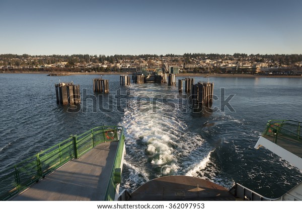 Edmonds, Washington Ferry\
Dock. A ferry boat pull out of the ferry dock traveling to Kingston\
on Bainbridge Island in the Puget Sound area of western Washington\
state.