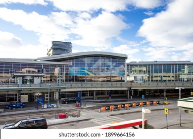 Edmonton, Alberta, Canada - January 20, 2021: View Of Edmonton International Airport Arrival And Departure Floors. New Air Traffic Control (ATC) Tower Is Behind The Terminal. No Cars On The Driveway. 