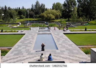 Edmonton, Alberta, Canada, July 17, 2019: People Visit The Aga Khan Garden At The University Of Alberta Botanic Garden In Edmonton.  The Garden Features Pathways, Terraces, And Still Pools. 