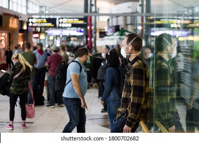 Edmonton, Alberta / Canada - July 23, 2020: People In The Departure Zone Of The Edmonton International Airport During Covid-19 Phase 2, A Young Guy Wearing Mask In Front. 