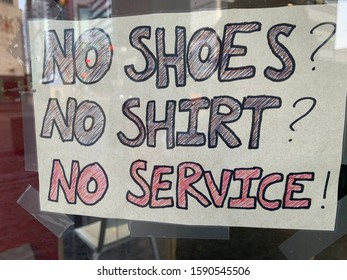 Edmonton, Alberta - December 16, 2019: A Sign Saying No Shoes No Shirt No Service In A Business’s Window 