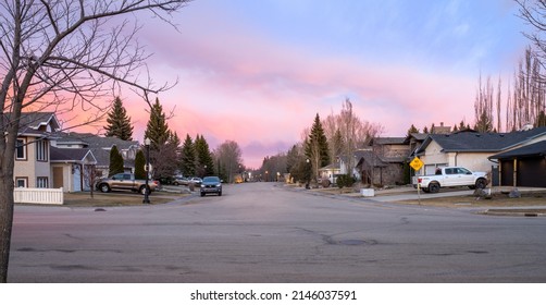 Edmonton, Canada, April8, 2022:East Direction View On City Street In Spring Season With Sunset Reflection Red Sky Background