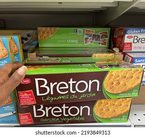 Edmonton, Canada - August 10, 2022: A Black Person Reaching For A Box Of Breton Garden Vegetable Crackers On A Grocery Store Shelf