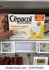 Edmonton, Canada - August 7, 2022: A Black Person Reaching For A Package Of Lemon Honey Flavoured Cepacol Lozenges On A Pharmacy Shelf