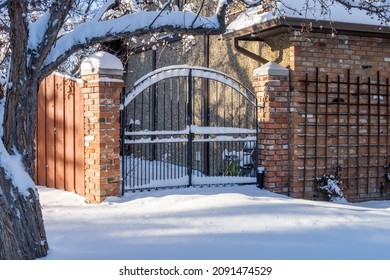 Edmonton, Canada, December 15, 2021: A Metal Gate  In Snow After Snowfall At Minus 24 Temperature