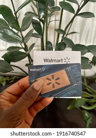 Edmonton, Canada - February 10, 2021: A Concept Image Of A Black Person Holding A Walmart Gift Card And Receipt