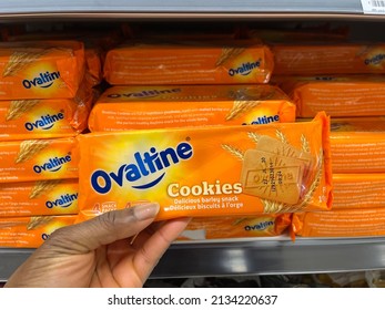 Edmonton, Canada - February 25, 2022: Black Person Reaching For A Package Of Ovaltine Biscuits On A Grocery Store Shelf