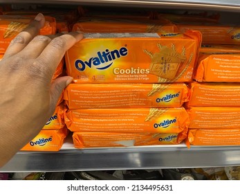 Edmonton, Canada - February 25, 2022: Black Person Reaching For A Package Of Ovaltine Biscuits On A Grocery Store Shelf