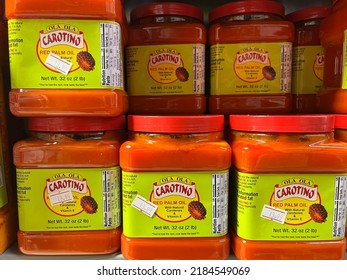 Edmonton, Canada - July 25, 2022: Jars of Ola Ola Carotino red palm oil on display on a grocery store shelf